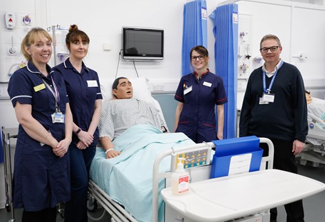 Advanced clinical practice students and apprentice with course leader