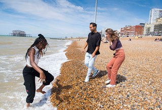 Students enjoying the sea on Brighton beach
