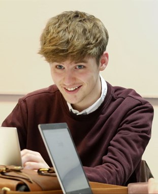 Declan working from a laptop 