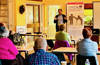 Dr Theo Fotis talking to a room of people sitting in chairs