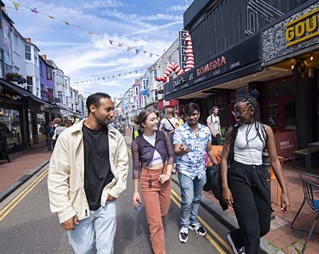 Four students walking through Brighton street