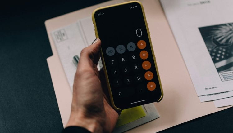 Hand holding a phone with a calculator app open