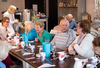 People having tea on a long table