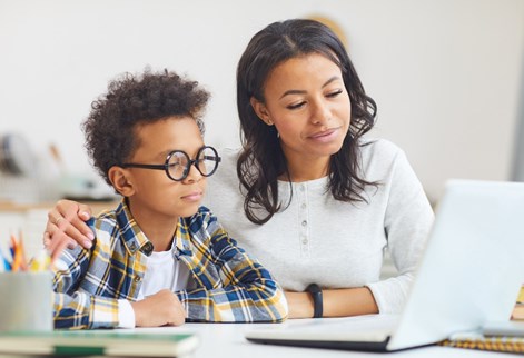 Adult and child looking at a laptop