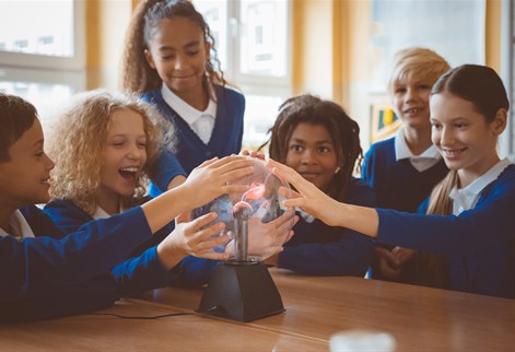 School children touching a plasma globe