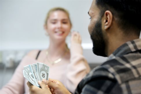Student with monopoly money