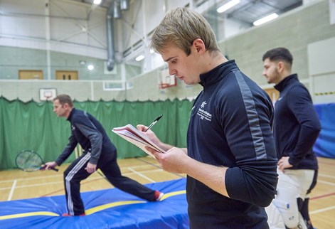 Sport student writing on a clipboard