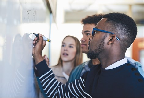 Students writing on a wipe board