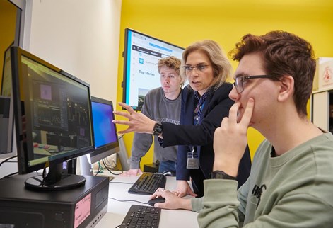 Two students and lecturer working in the user centred design lab