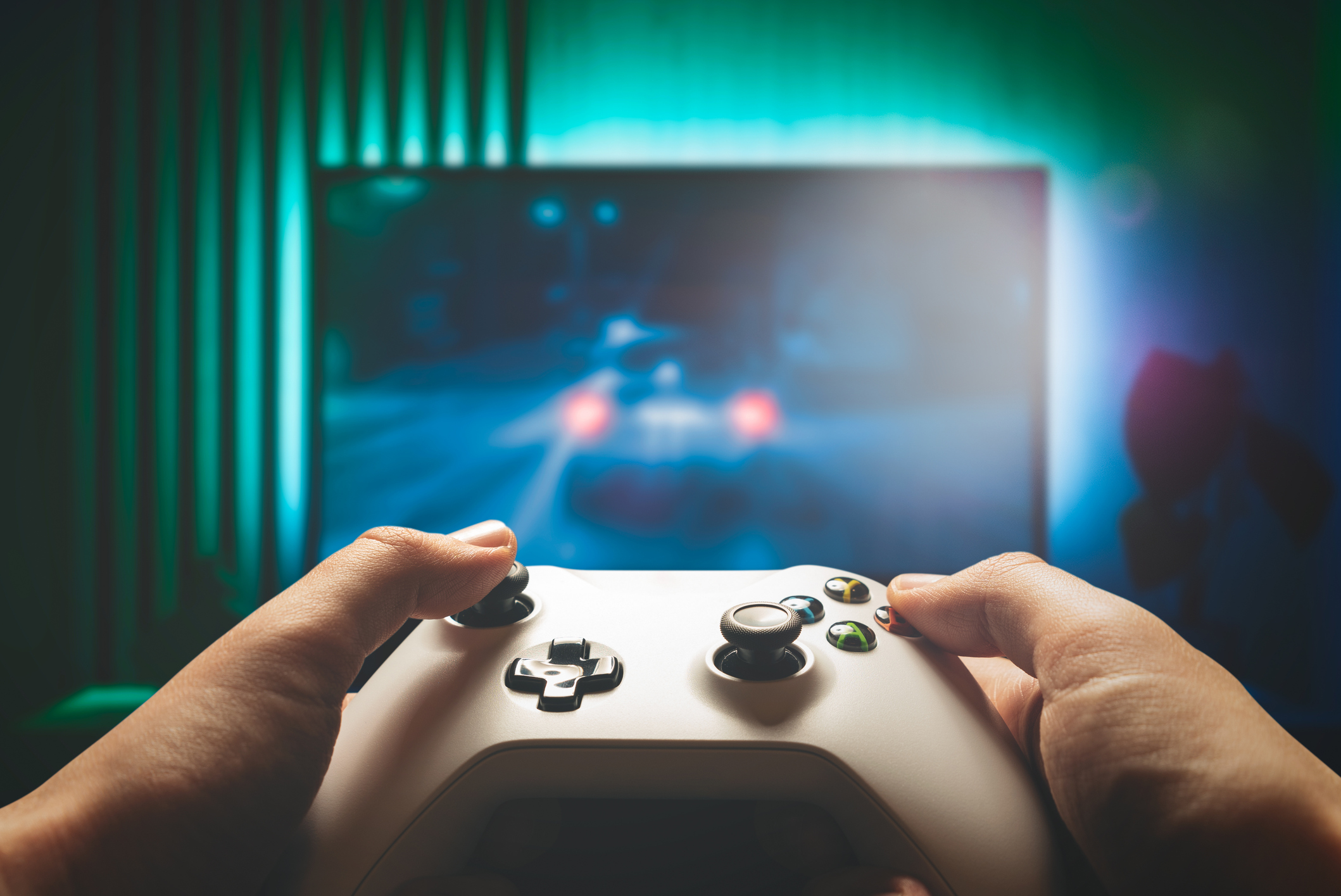 Two hands on an Xbox controller